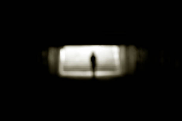 istock Human silhouette in an underground passage in blur. 1271273230