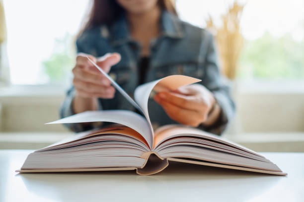 istock a woman opening and reading book 1271273322