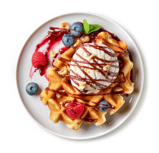 dessert of belgian waffle and fresh berries isolated on white