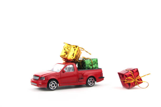bright wrapped gifts on red pickup isolated on white background. Gift giving concept