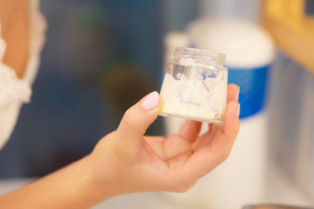istock Moisturizing cream in female hands in bathroom 1271276573