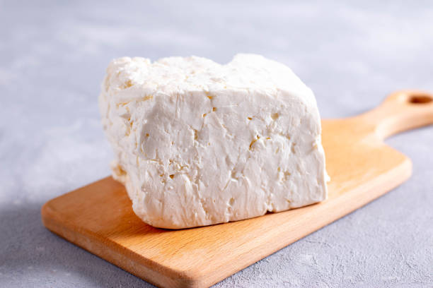 istock Sliced fresh white cheese from cow's milk on a cutting board 1271276915