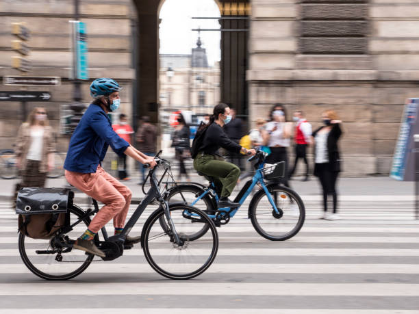 PARIS, FRANCE - SEPTEMBER 03, 2020: More people use the bike or the Electric Scooter to get around town stock photo
