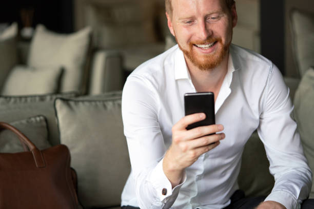 istock Young businessman sending message with mobile phone 1271278284