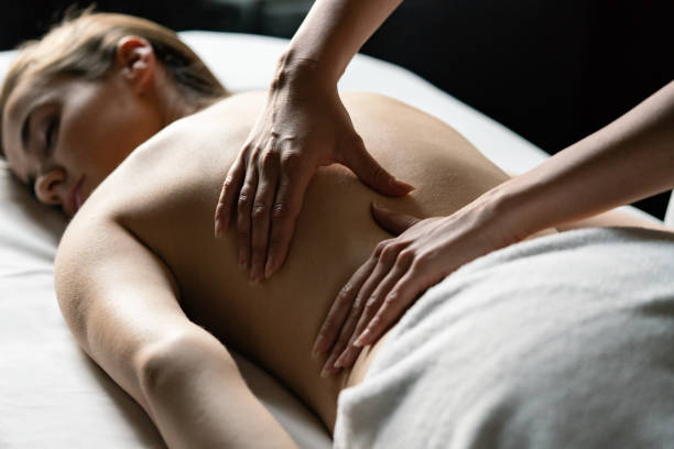 istock Young beautiful woman having massage in spa salon 1271278324