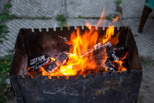 istock Barbecue grill mangal preparation with roaming fire outside building. Burns a firewood 1271278493