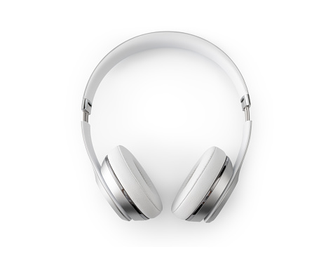 Close-up stylish white headphones in female hand on dark background. Copy space, mock-up, template, blank. Concept of music in daily life