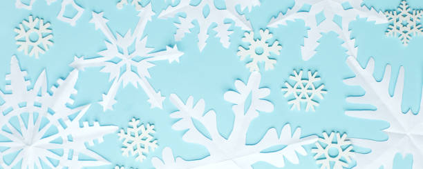 istock Christmas wallpaper with empty space for text. White Paper snowflakes on blue background. Blue winter holiday background with handmade snow, Xmas, New 2021 Year holiday banner 1271280061