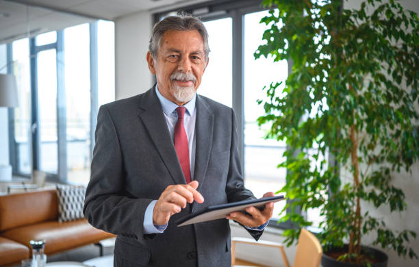 istock Candid Portrait of Working Senior Using Digital Tablet 1271281135
