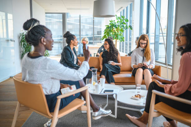 istock Female Corporate Executives Meeting in Modern Office Lobby 1271281142