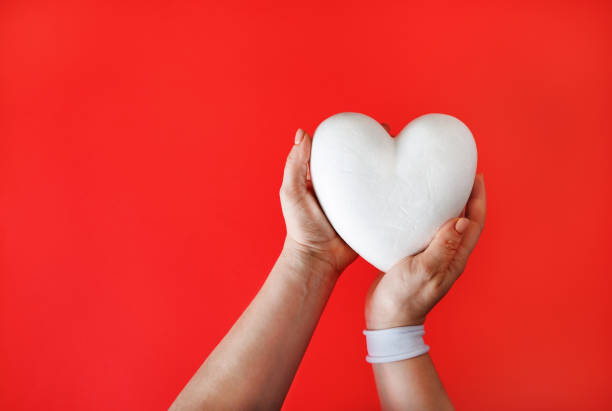 istock White heart in hands 1271282623
