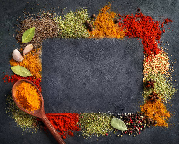 istock Frame of various spices and herbs on dark background. Copy space. 1271284015