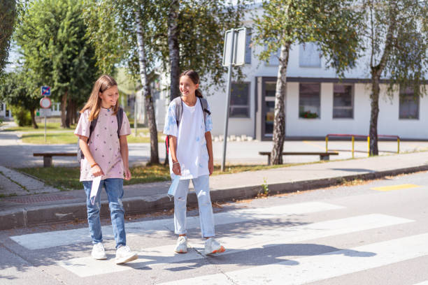 istock Two girls walking home from school wearing face masks 1271284111
