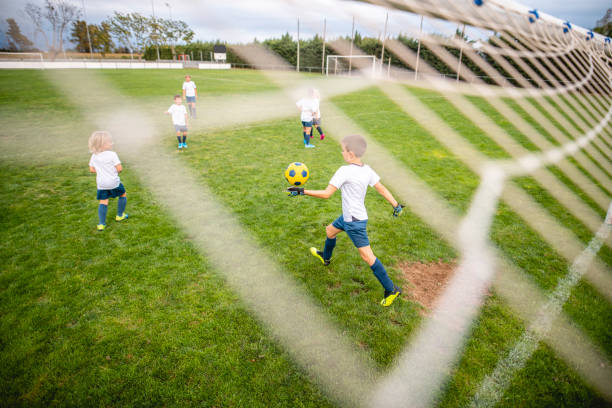 istock Young Boy Goalie Preparing to Kick Ball Down Field 1271284144