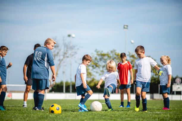 istock Young Boy Footballers Practicing with Teenagers 1271284937
