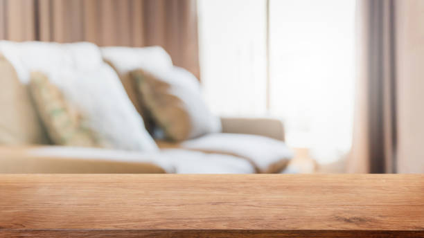 istock Empty wood table top and blurred living room in home interior with curtain window background. - can used for display or montage your products. 1271286490