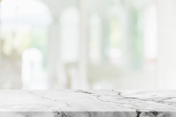 istock Empty white marble stone table top and blur glass window interior cafe and restaurant banner mock up abstract background - can used for display or montage your products. 1271286497