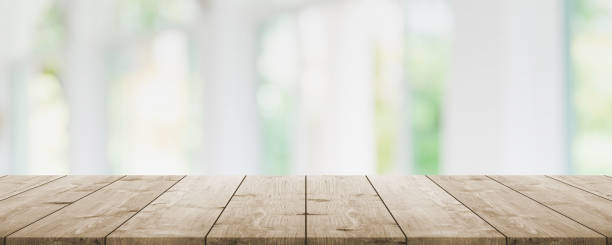 istock Empty wood table top and blur glass window interior restaurant banner mock up abstract background - can used for display or montage your products. 1271286514