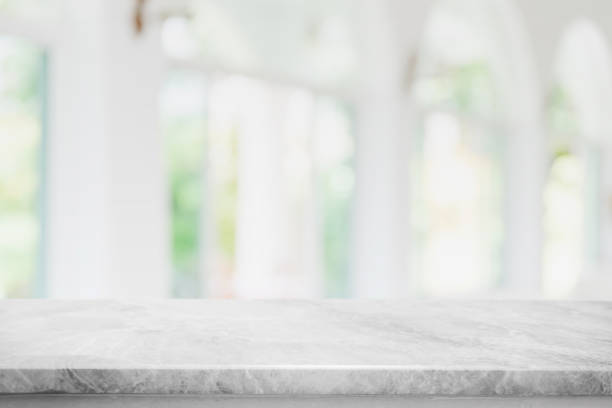 istock Empty white marble stone table top and blur glass window interior cafe and restaurant banner mock up abstract background - can used for display or montage your products. 1271286534