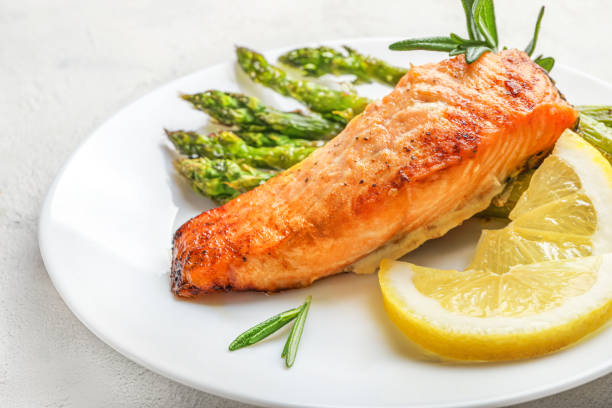 istock Delicious lunch, baked salmon with asparagus 1271287041