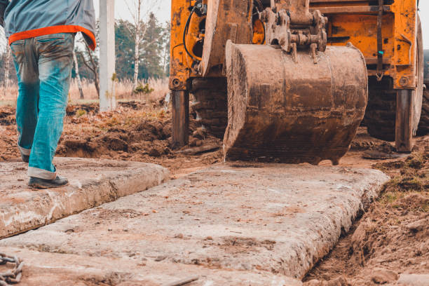 istock The excavator installs concrete slabs for the road. 1271287083