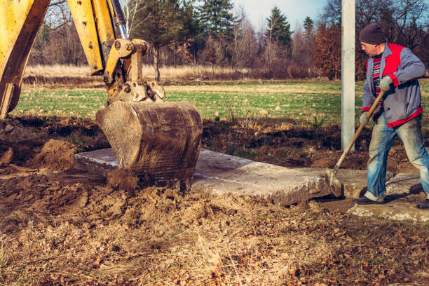 istock The bucket excavator pulls up concrete slabs to set the road. 1271288095