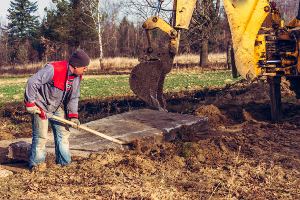 istock The bucket excavator pulls up concrete slabs to set the road. 1271288196
