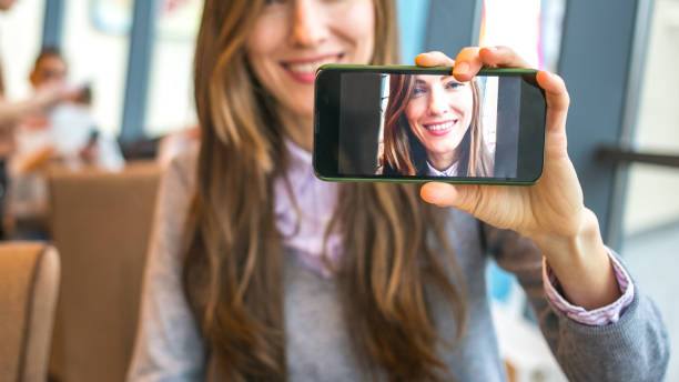 istock Young woman with smart phone taking selfie 1271289773
