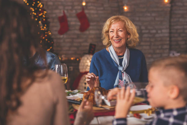 istock Mother and daughter speaking over Christmas dinner 1271295486