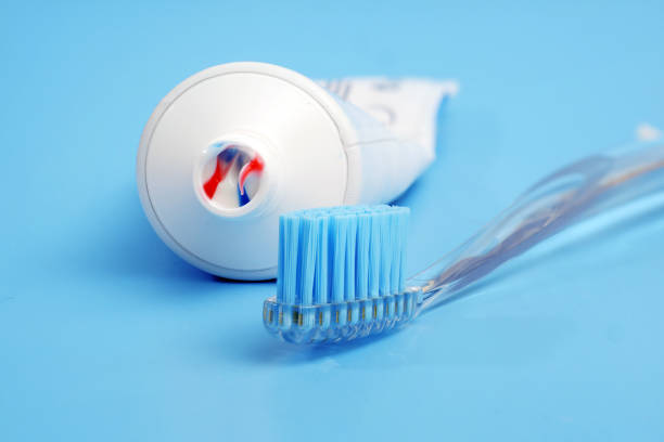 istock toothbrush with toothpaste on it and white toothpaste tube on blue background 1271295575