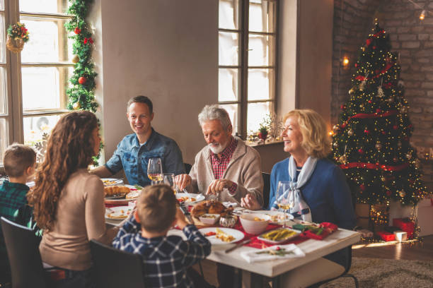 istock Family gathered for Christmas dinner 1271295742