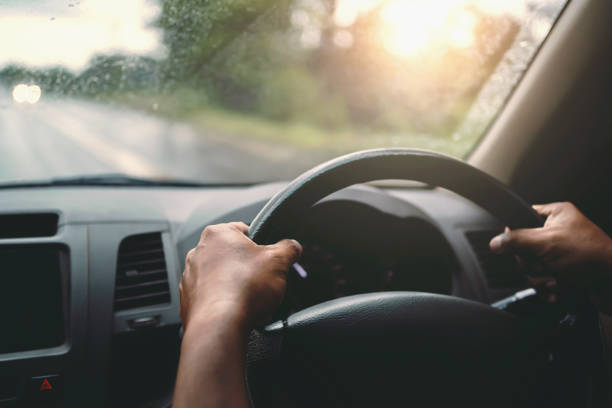 istock closeup hand driver car on road 1271296596