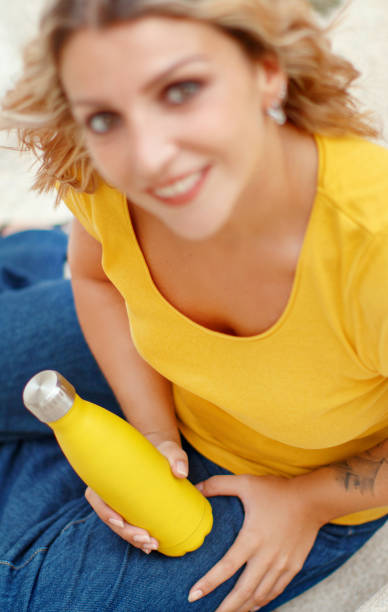 istock Young woman holding yellow reusable bottle 1271298549