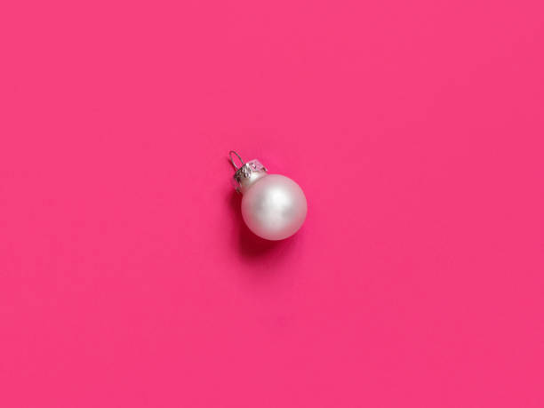 istock Silver Christmas bauble on a pink background 1271298567