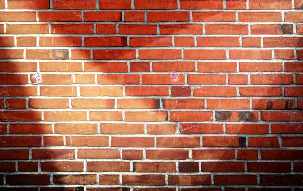 istock Aged and weathered brick wall textures with very bright spotlight illumination 1271298873