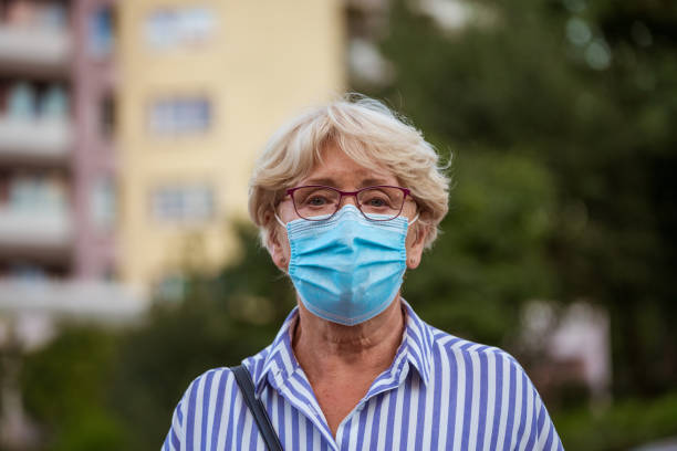 istock Senior woman wearing face mask 1271299753
