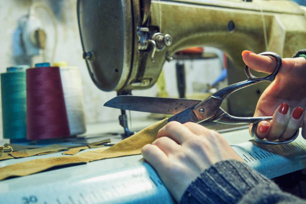 istock Woman tailor using retro sewing machine at home, hobby concept. 1271300979