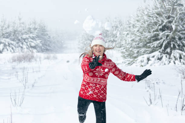 istock Snowball flying through the air as it leaves womans hands 1271302514