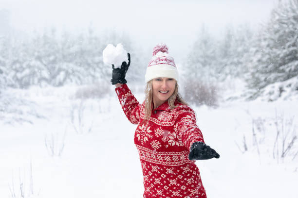 istock Woman throwing a large snowball 1271302753