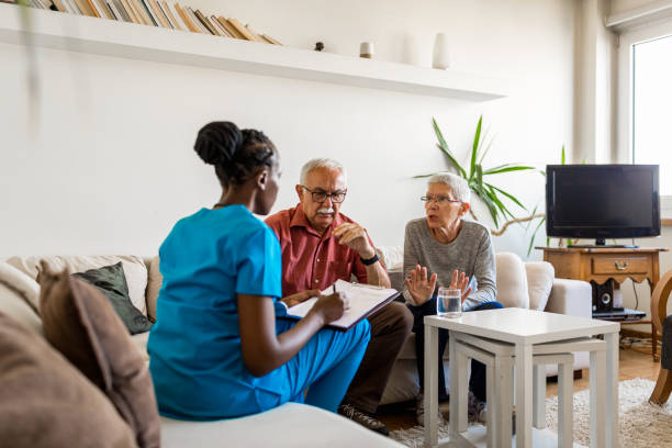 istock Nurse in the home visit helping senior couple 1271304462