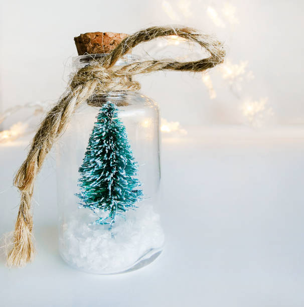 istock Green Christmas tree in a glass jar on a white background 1271305192
