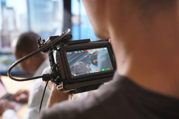 istock Close-up of the shooting camera and the working operator 1271305532