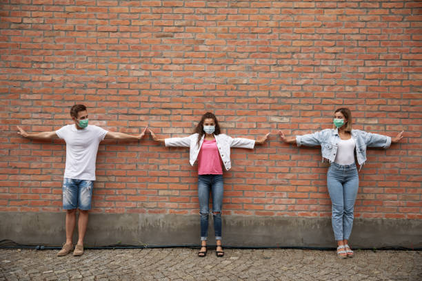 istock Standing against the wall and keeping social distance 1271305981