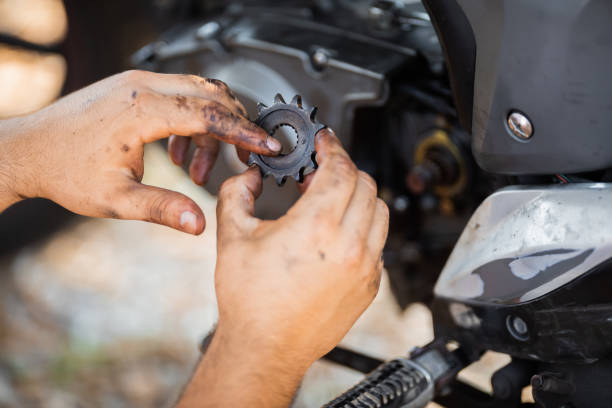istock Young man repairs the coupling on his motorbike 1271307528