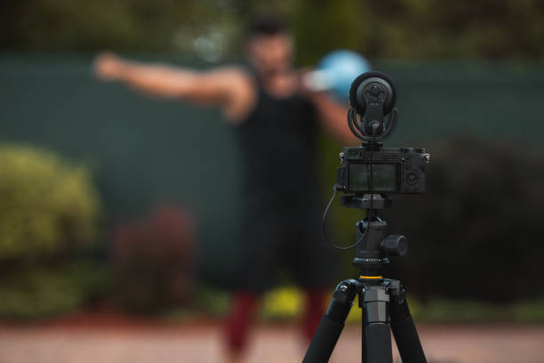 istock Male athlete doing exercise in backyard and filming vlog. 1271308972