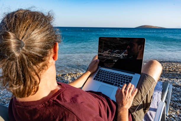istock Young business man working with laptop by the sea 1271309209
