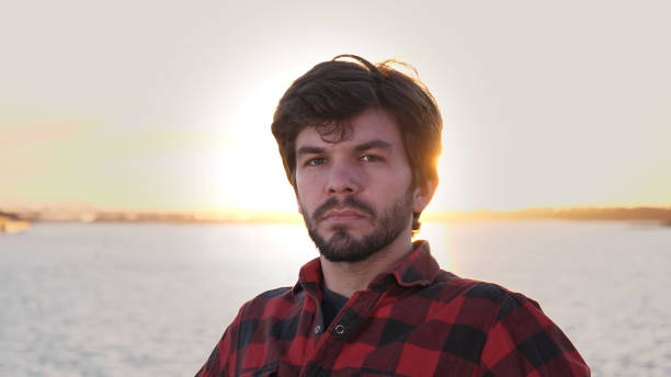 istock Happy man smiling to camera outdoors during sunset 1271310050