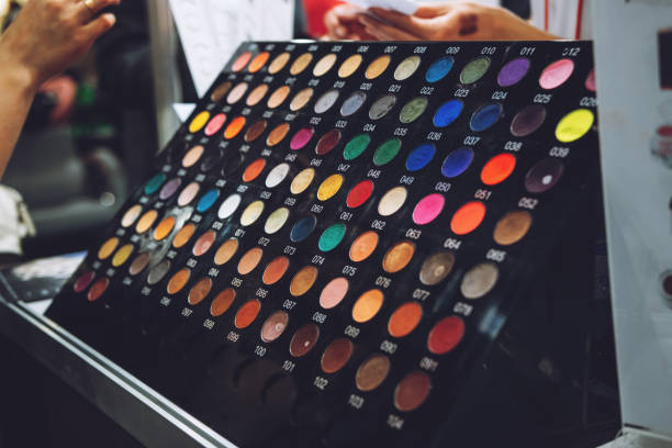 istock Decorative cosmetics tester zone, samples, testers. Various eye liners, brow sticks in showcase of beauty shop. Stand with bright colored tester eye shadow samples in beauty store 1271312966