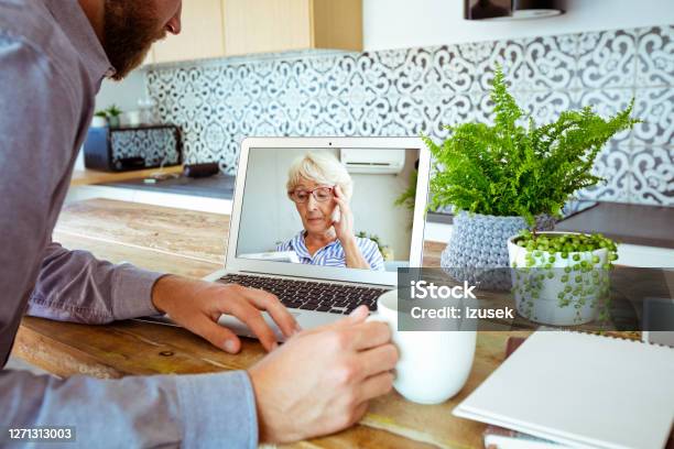 Young Man During Video Call With Grandmother Stock Photo - Download Image Now - Adult, Adults Only, Advice