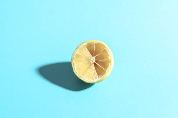 istock Sliced lemon on a blue background. Conceptual minimalism. 1271313061